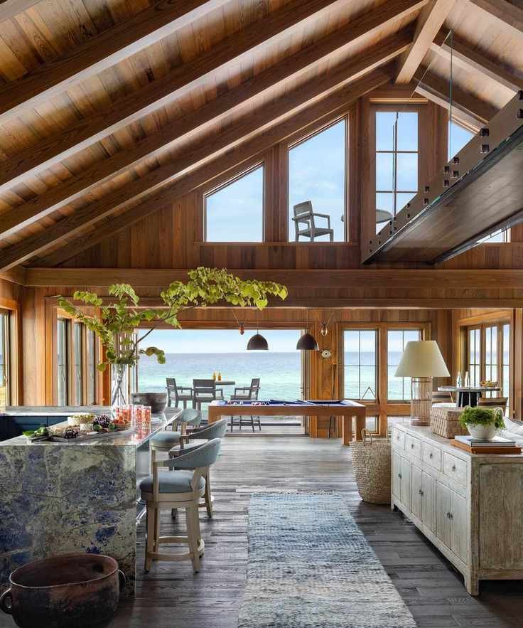 Double height space with seating and dining areas and view to ocean