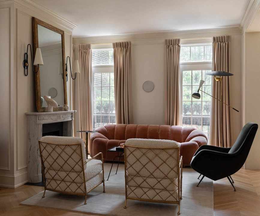 cream living room with pink curved sofa by Wendy Labrum
