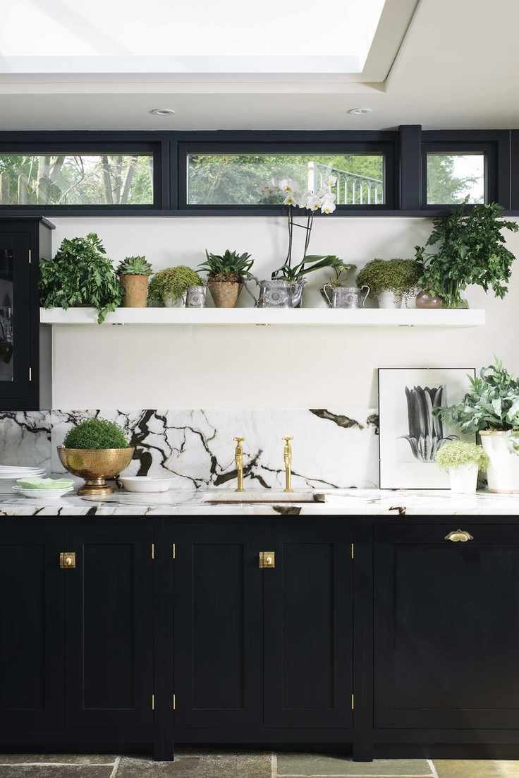 Kitchen with black cabinets and marble