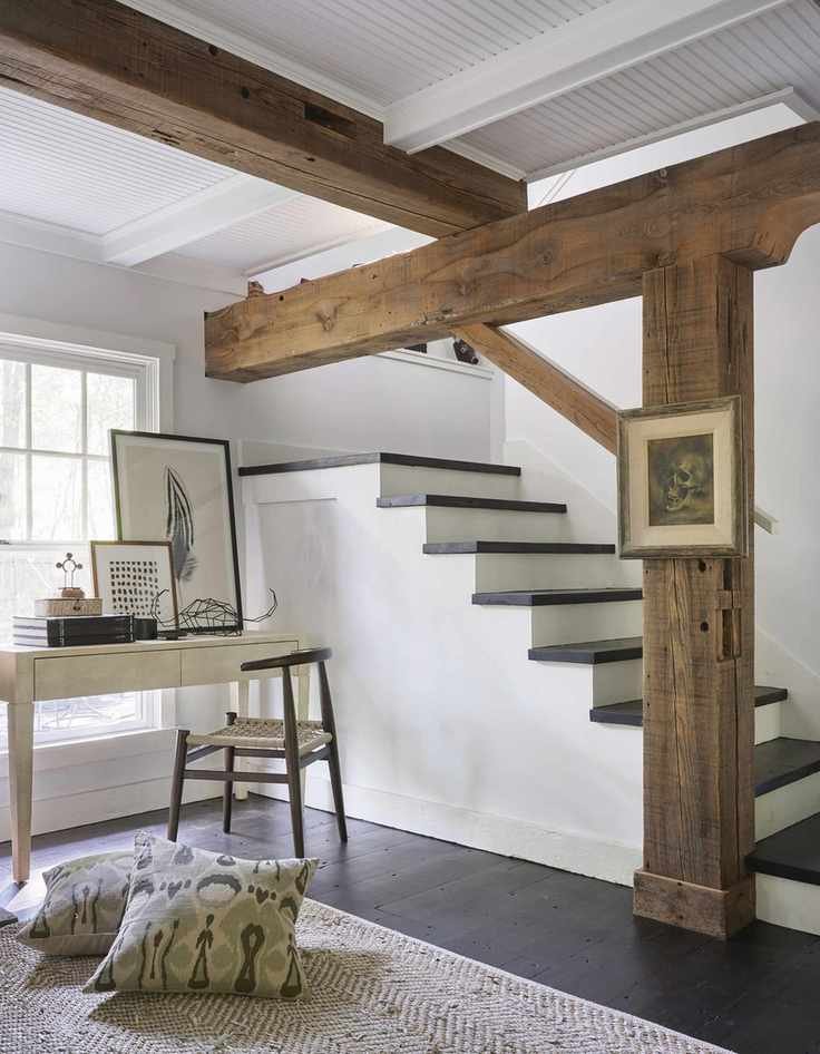Basement with window, beams, dark wood floor, stairs down, desk and chair