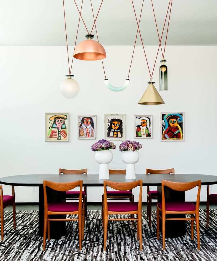 Dining room featuring dark wood chairs and a variety of pendant lights