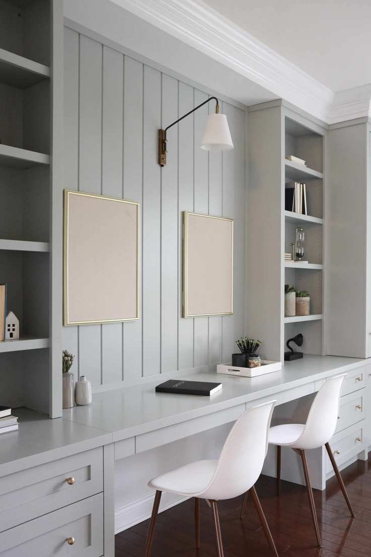 Modern office with painted wooden desk, shelves and drawers and minimalist design