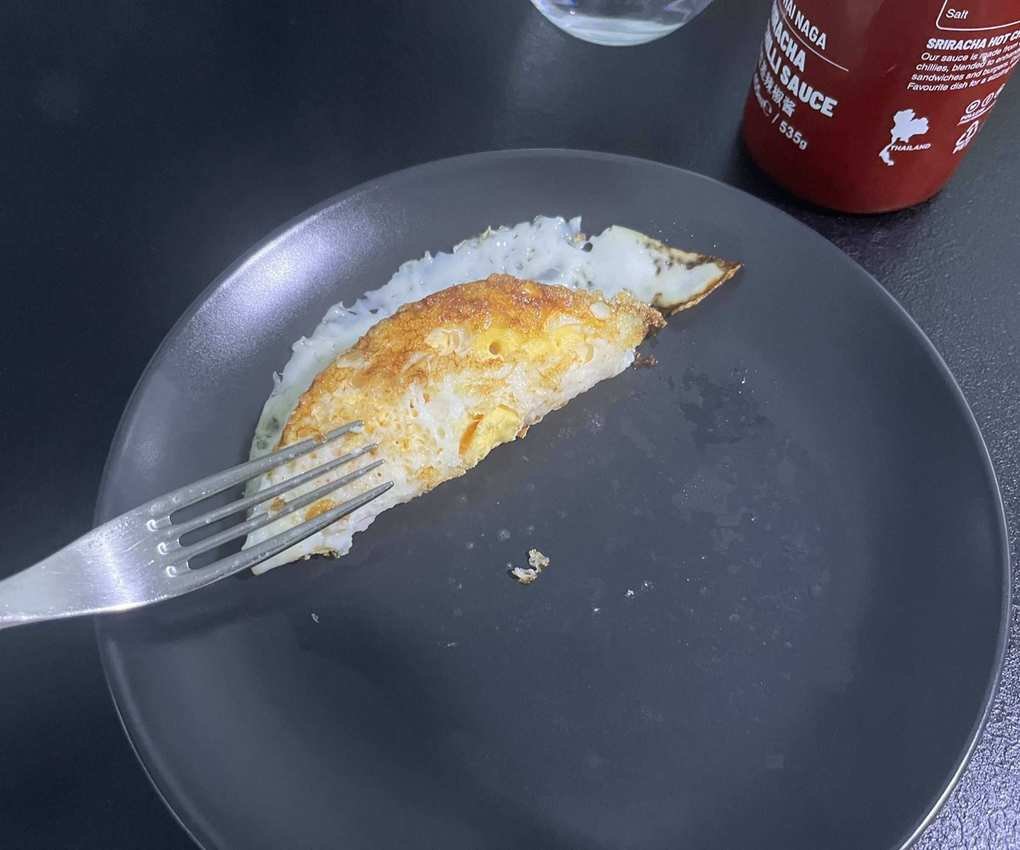 Crispy fried egg on a grey plate.