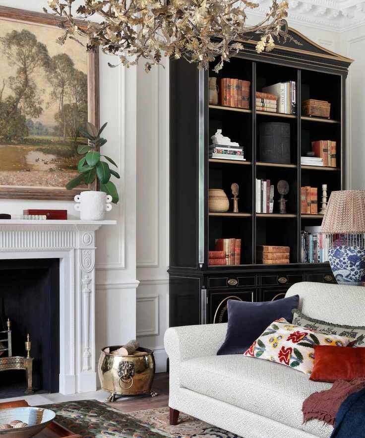White living room with dark built-in bookshelves