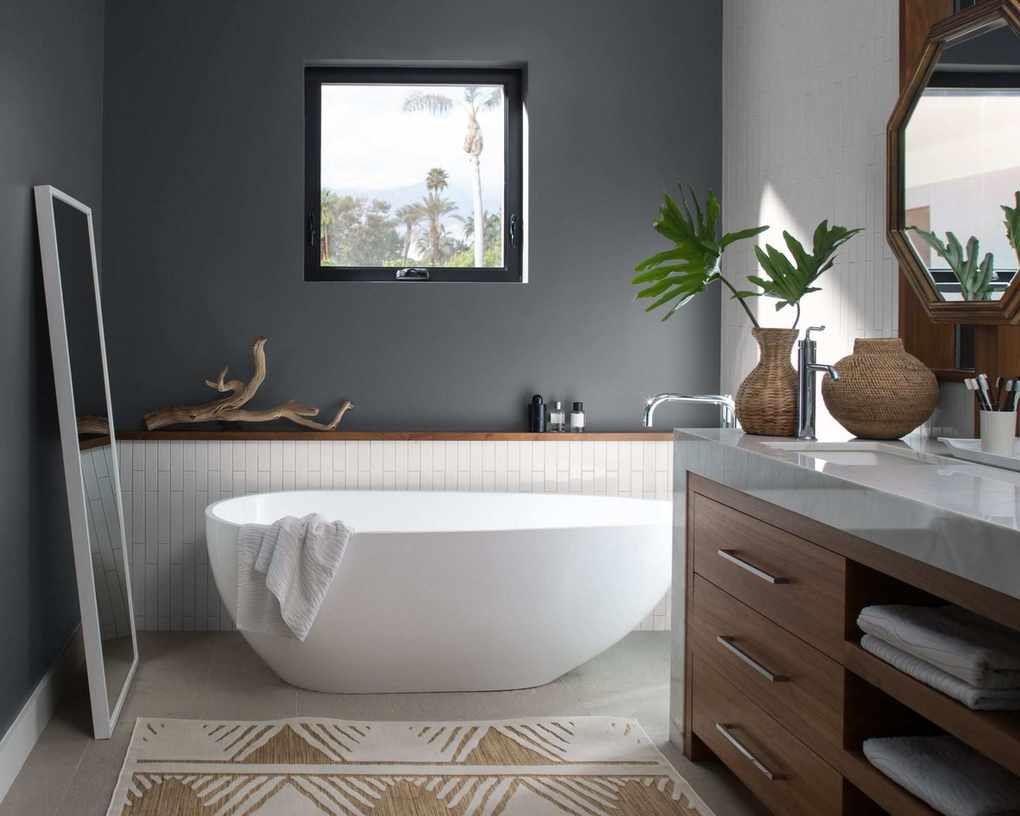 A modern bathroom with very dark grey walls