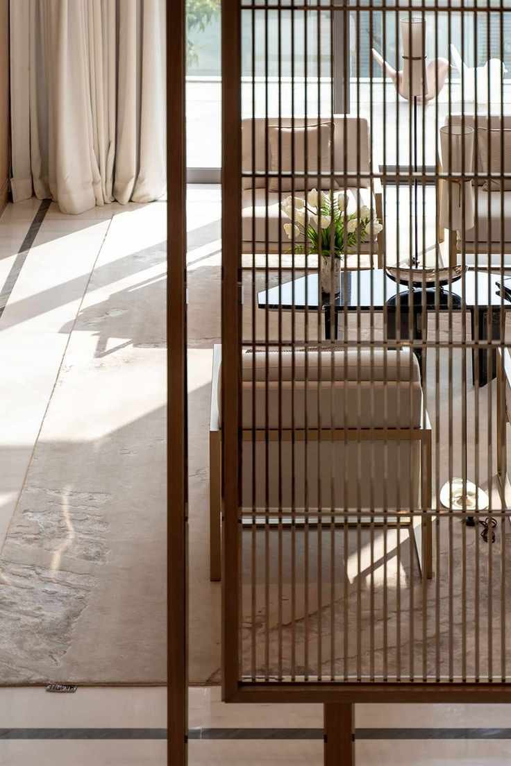 Apartment living room with slatted screen divider