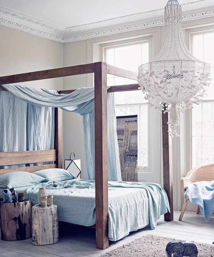A bohemian-style bedroom featuring a netted fabric chandelier