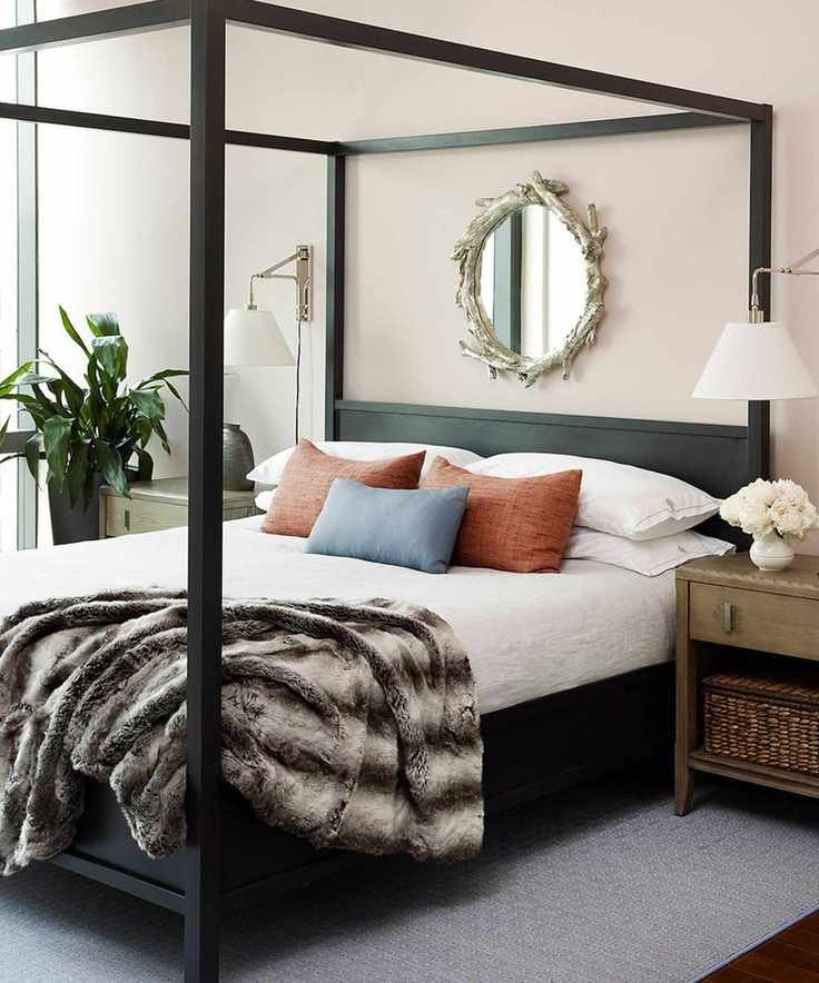 Black four poster bed and wooden bedside table