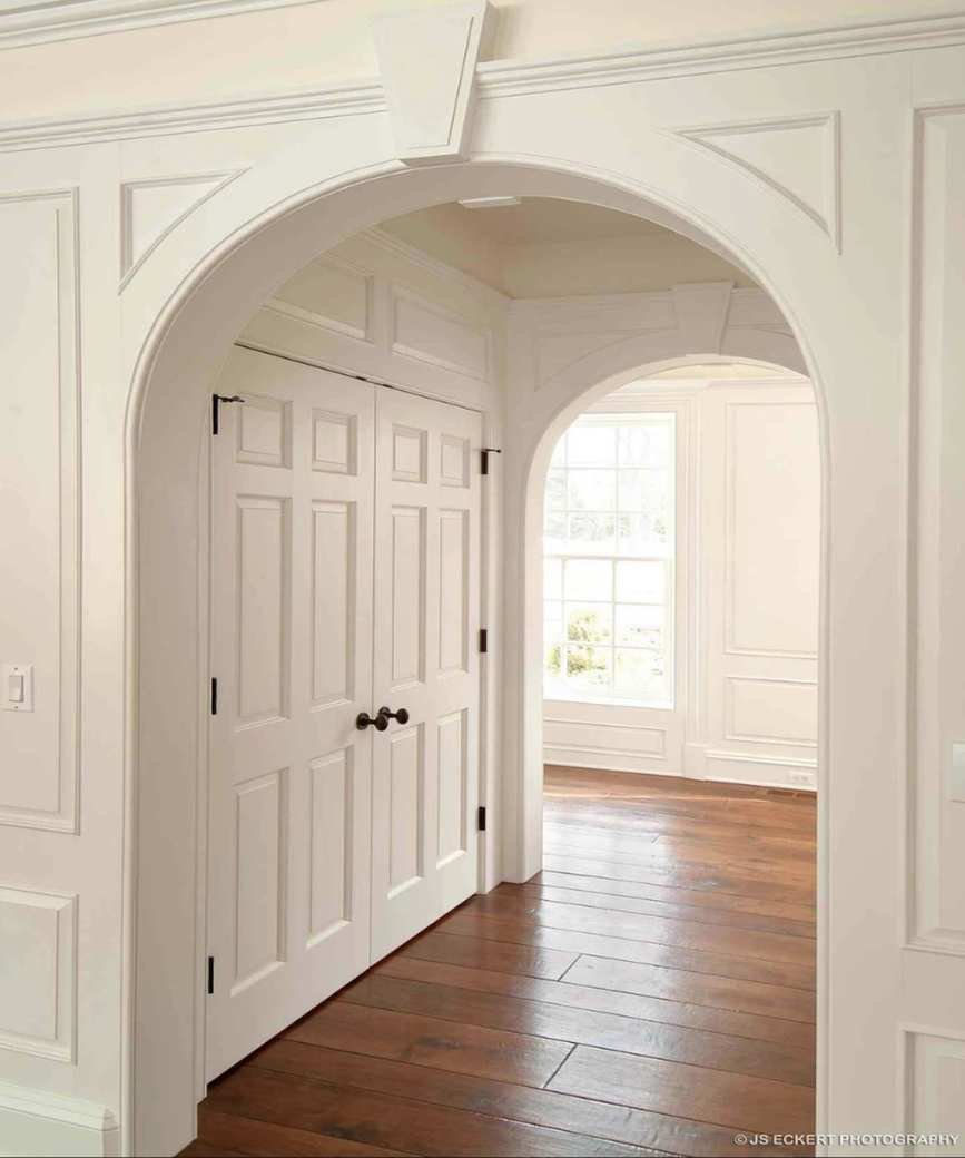 A built-in closet in an archway by Melichar Architects