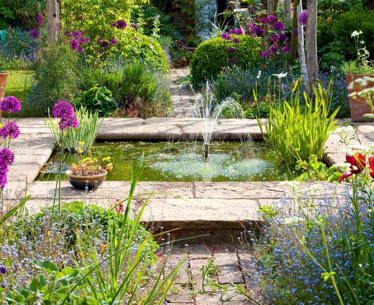 garden fountain in a wildlife pond in a country garden