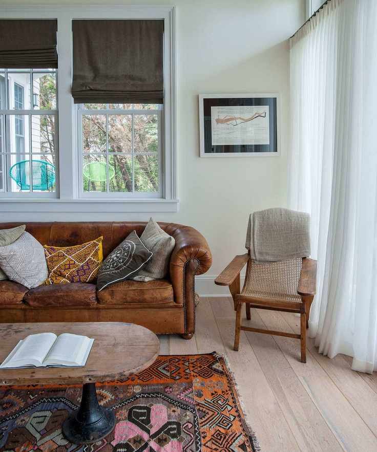 Rustic leather sofa with patterned rug