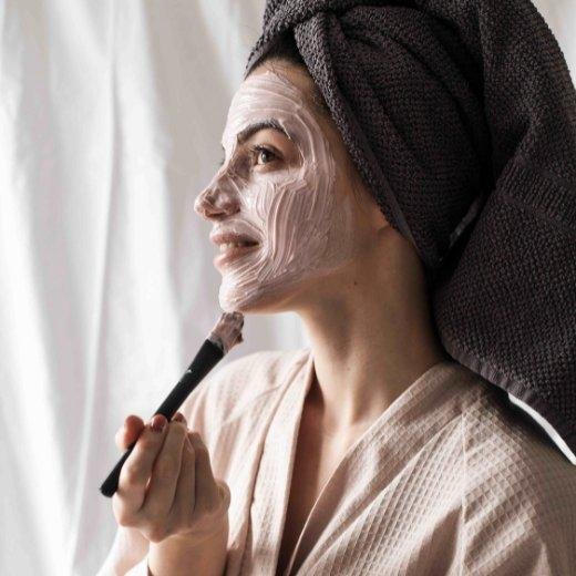 Applying a skin care face mask after showering Applying a skin care face mask after showering