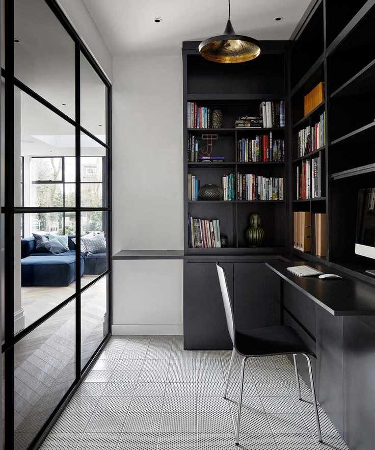 Home office hidden behind a partition in glass