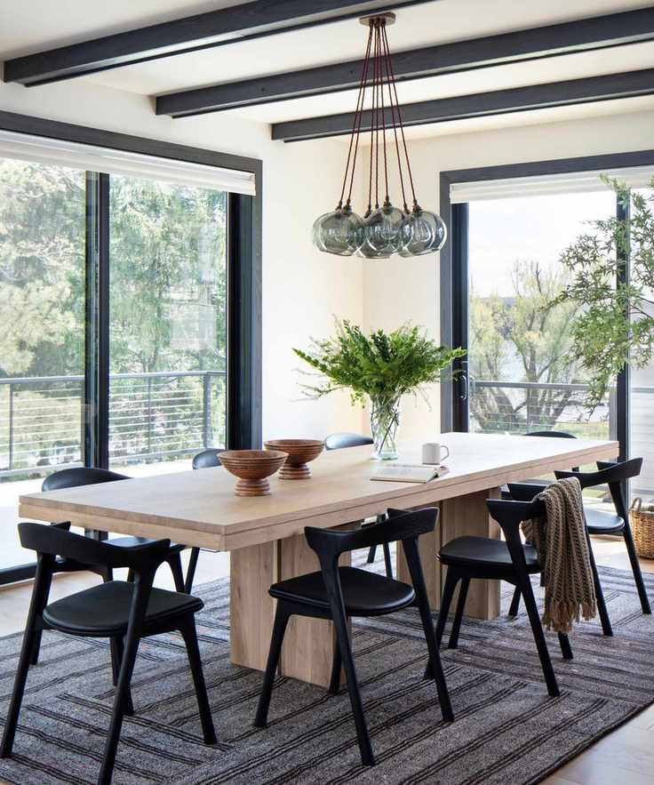 Neutral dining room with large windows