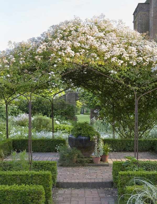 Rose garden ideas - Rose garden growing over pergola at Sissinghurst