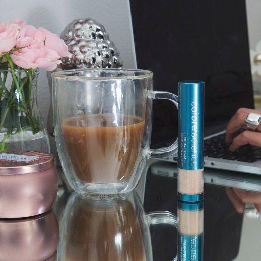 Image of Colorescience Brush On Shield SPF 50 on desk next to coffee