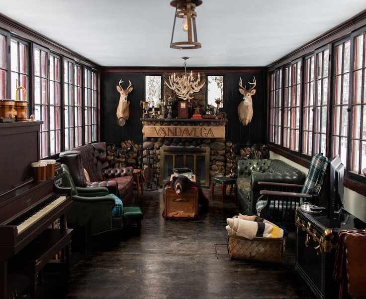 large cabin living room with dark walls and fireplace