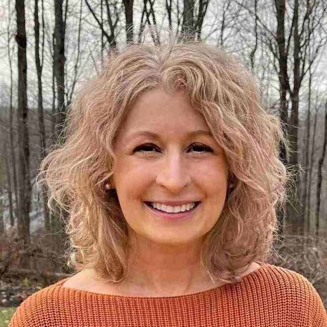 Pam Hartnett stood in front of trees