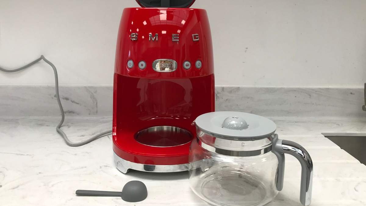 The red smeg drip coffee maker on a marble countertop