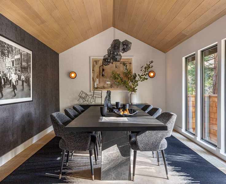 Dining room with a wood-clad vaulted ceiling and modern furnishings