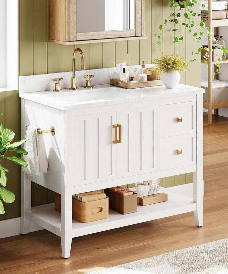 A green paneled bathroom with a white vanity and gold hardware