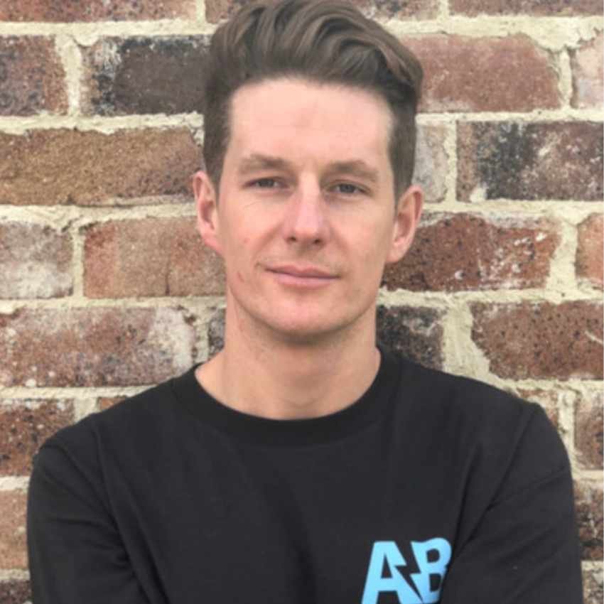 Headshot of Adam Bushell in a black t-shirt