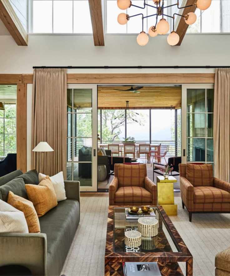 living room with statement light fixture, checkered armchairs