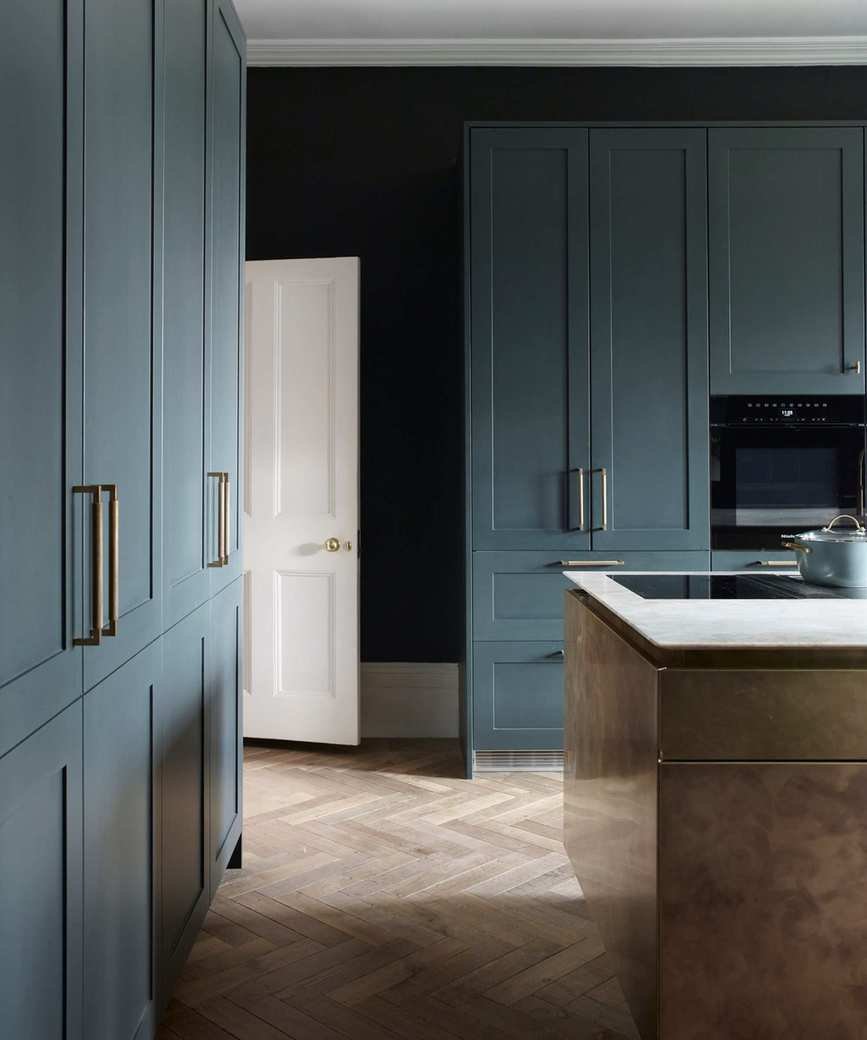 Black walls, blue cabinets, wooden floor