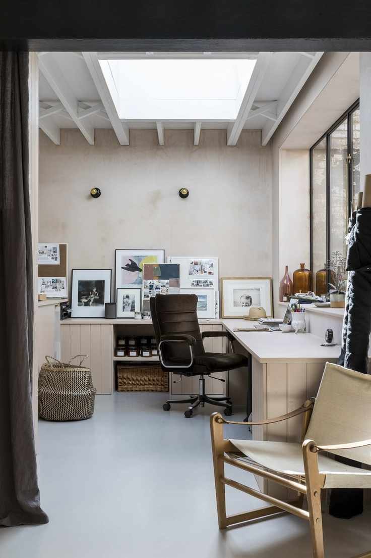 Corner desk in home office with chair and pictures