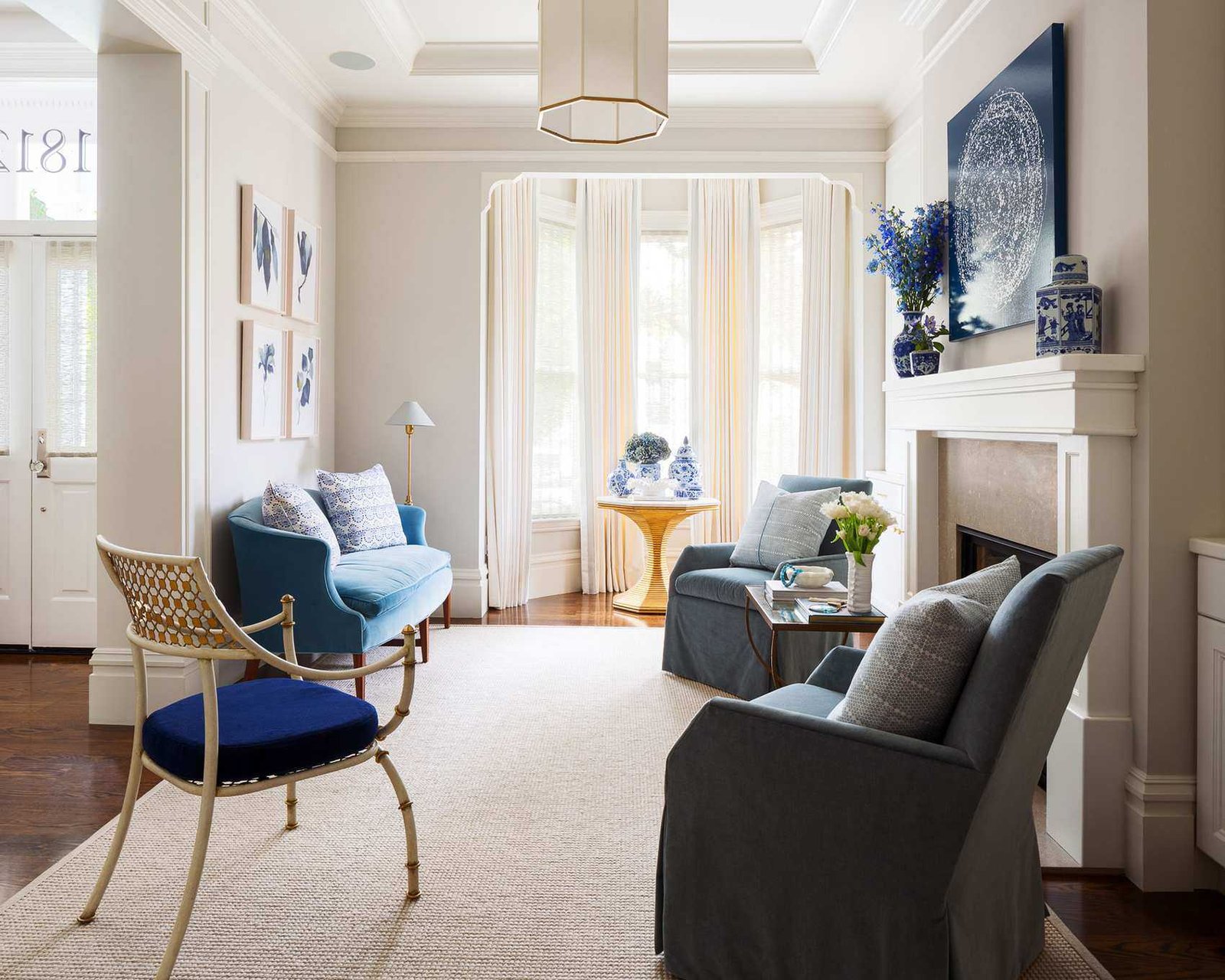 Beige living room with blue soft furnishings and neutral rug