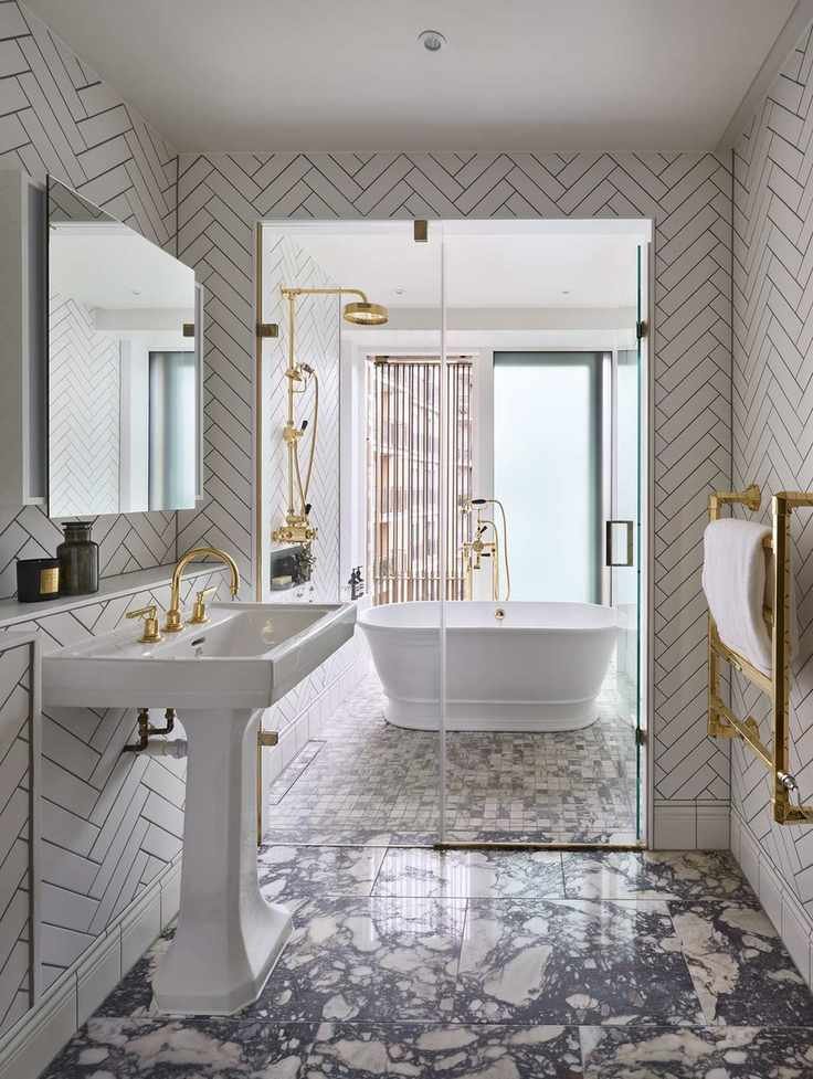 Bathroom showcasing a mix of marble and chevron wall tiles