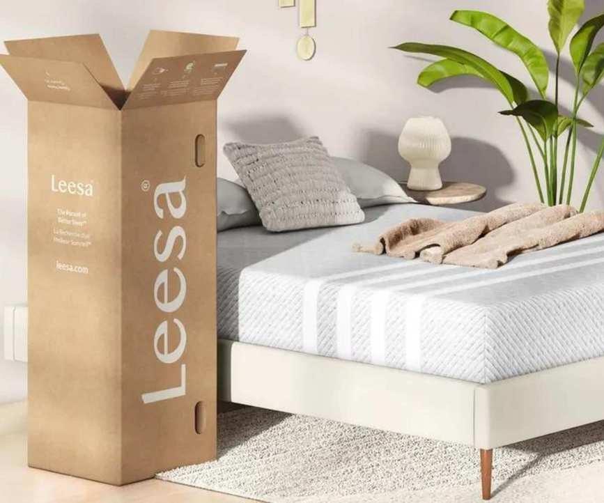 A mattress delivery box next to a mattress.