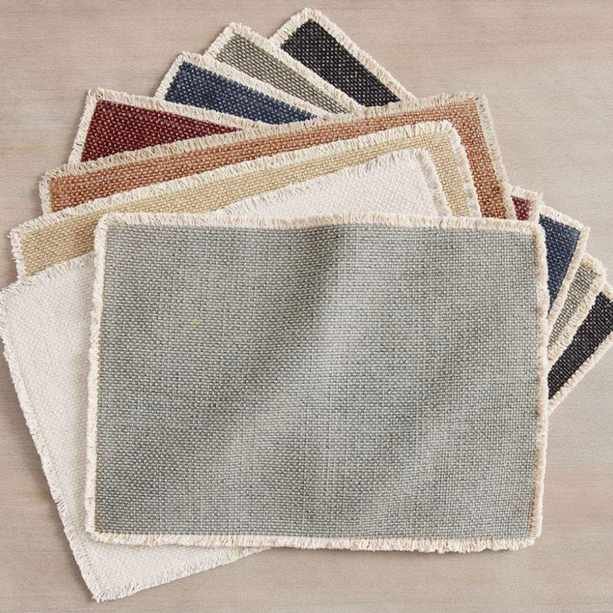 Set of cotton placemats with fringed edging in muted shades
