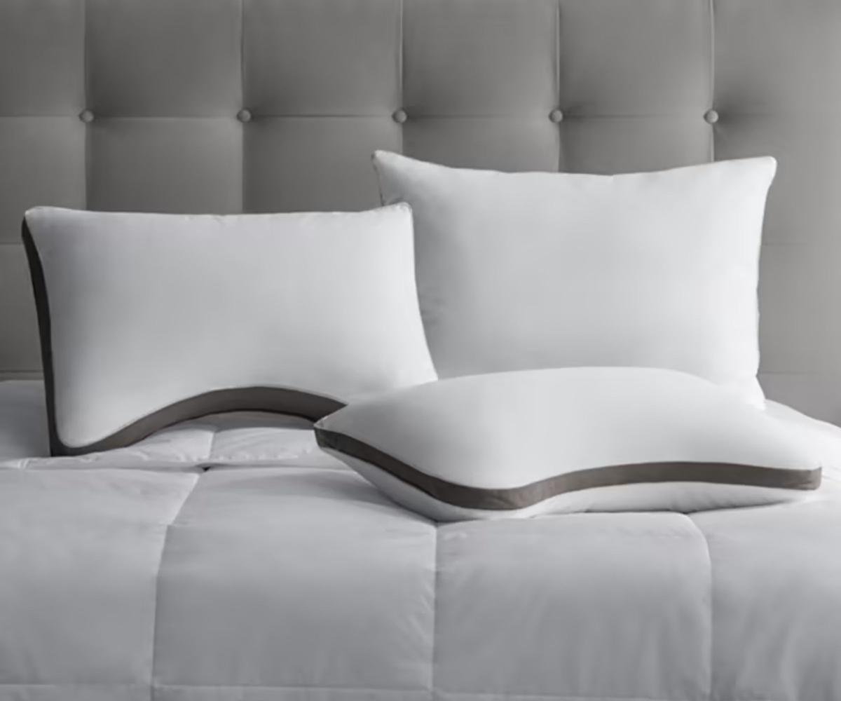 3 PlushComfort Pillows on a bed.