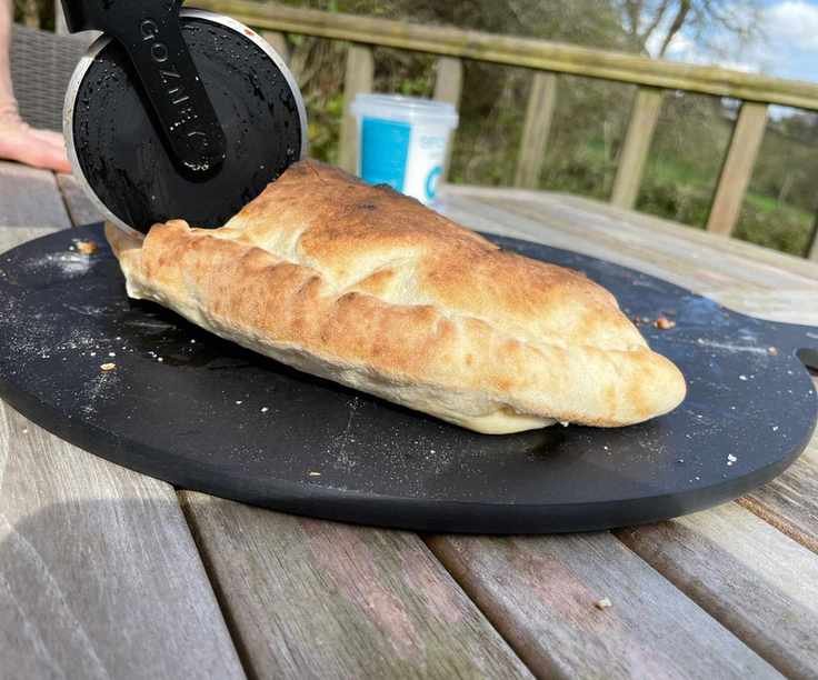 A calezone made in the Gozney Arc being cut in two