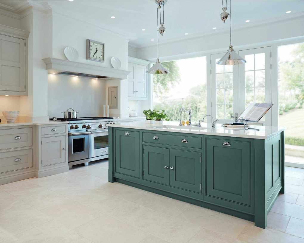 Open plan kitchen featuring a green kitchen island in white kitchen.
