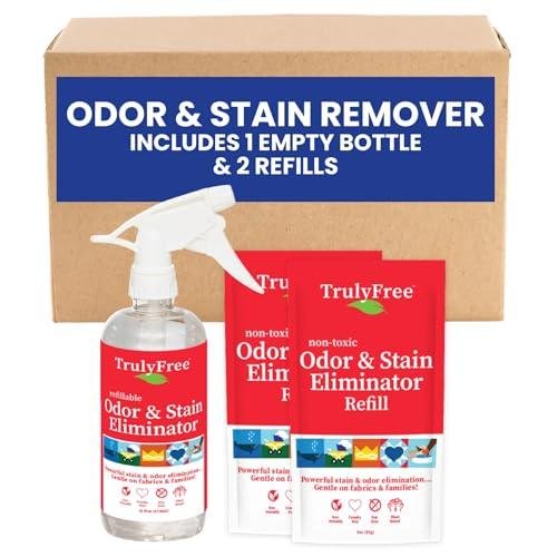 Two red stain remover cleaner packets, with a matching spray bottle. In front of a cardboard box.