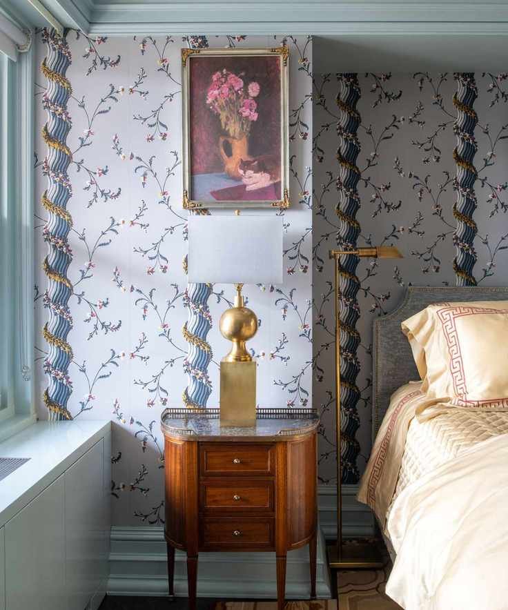 blue floral wallpapered bedroom with matching blue ceiling trim