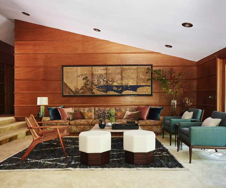 Midcentury living room with wood panelling, green armchairs, velvet sofa and midcentury wood chair