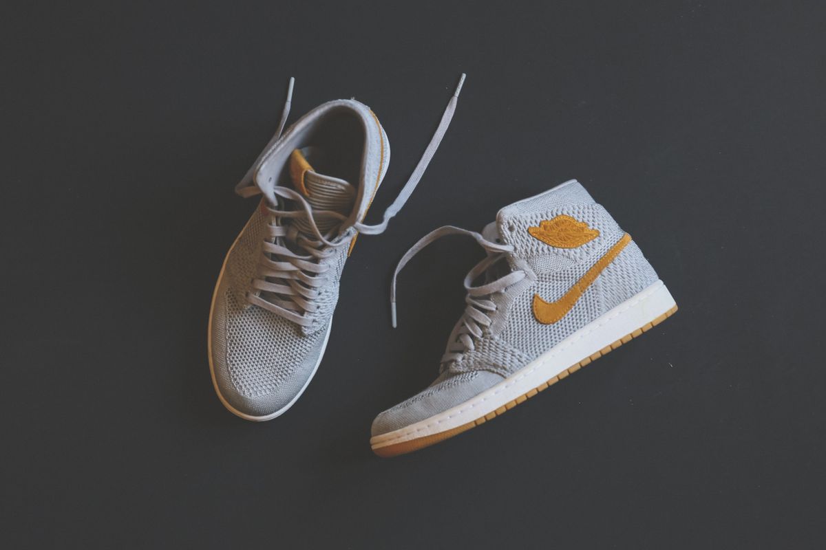 Nike Air Jordan 1 grey and gold high-top sneakers